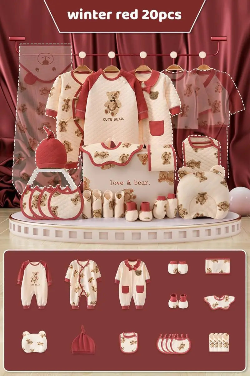 Display of a winter-themed baby clothing set in red and cream, featuring 20 pieces including onesies, bibs, shoes, and a bear pillow, with "Cute Bear" and "Love & Bear" motifs.