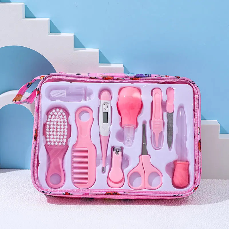 A pink baby grooming kit with a comb, brush, thermometer, nail clippers, scissors, and more, neatly arranged in a plastic case against a blue background with geometric shapes.