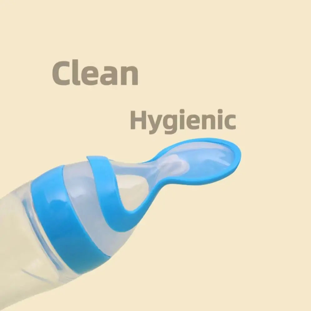 Close-up of a clear baby bottle with a blue cap and a spoon attachment. The words "Clean" and "Hygienic" are written above, highlighting the product's cleanliness.