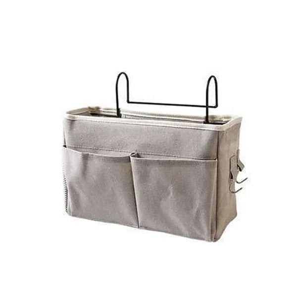 Gray fabric storage organizer with two front pockets and metal hooks for hanging. Ideal for organizing small items, suitable for attaching to a surface or shelf.