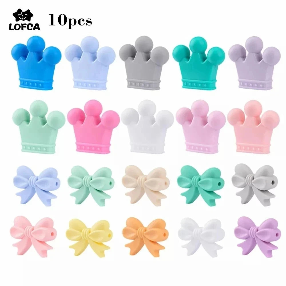 Silicone beads shaped like crowns and bows in various pastel colors, including blue, gray, green, pink, and white. The set contains 10 pieces and is labeled with "LOFCA."