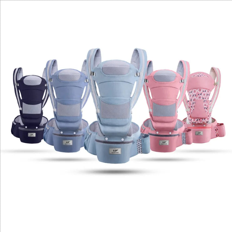 Five baby carriers in various colors and patterns, including navy, light blue, and pink with floral print, are arranged in a row, showcasing their design and features.
