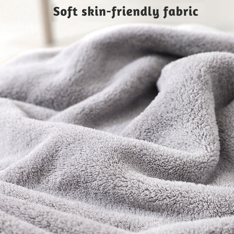 Close-up of a gray, plush, textured fabric with text reading "Soft skin-friendly fabric" at the top, highlighting its cozy and gentle material.