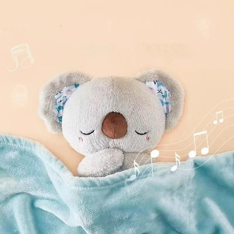 A cute koala plushie with closed eyes and patterned ears is tucked under a soft blue blanket, with musical notes floating against a peach background.