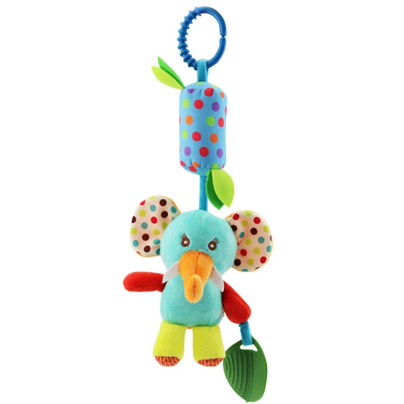 Colorful plush elephant toy with polka-dot ears, an orange trunk, and green leaf attached. Hanging from a blue ring, it features vibrant green and red limbs and multicolored body.
