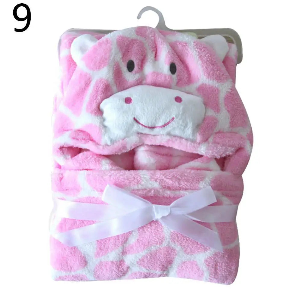 Pink and white hooded baby blanket with a smiling giraffe face, folded neatly and tied with a white ribbon. Number 9 is displayed in the top left corner.