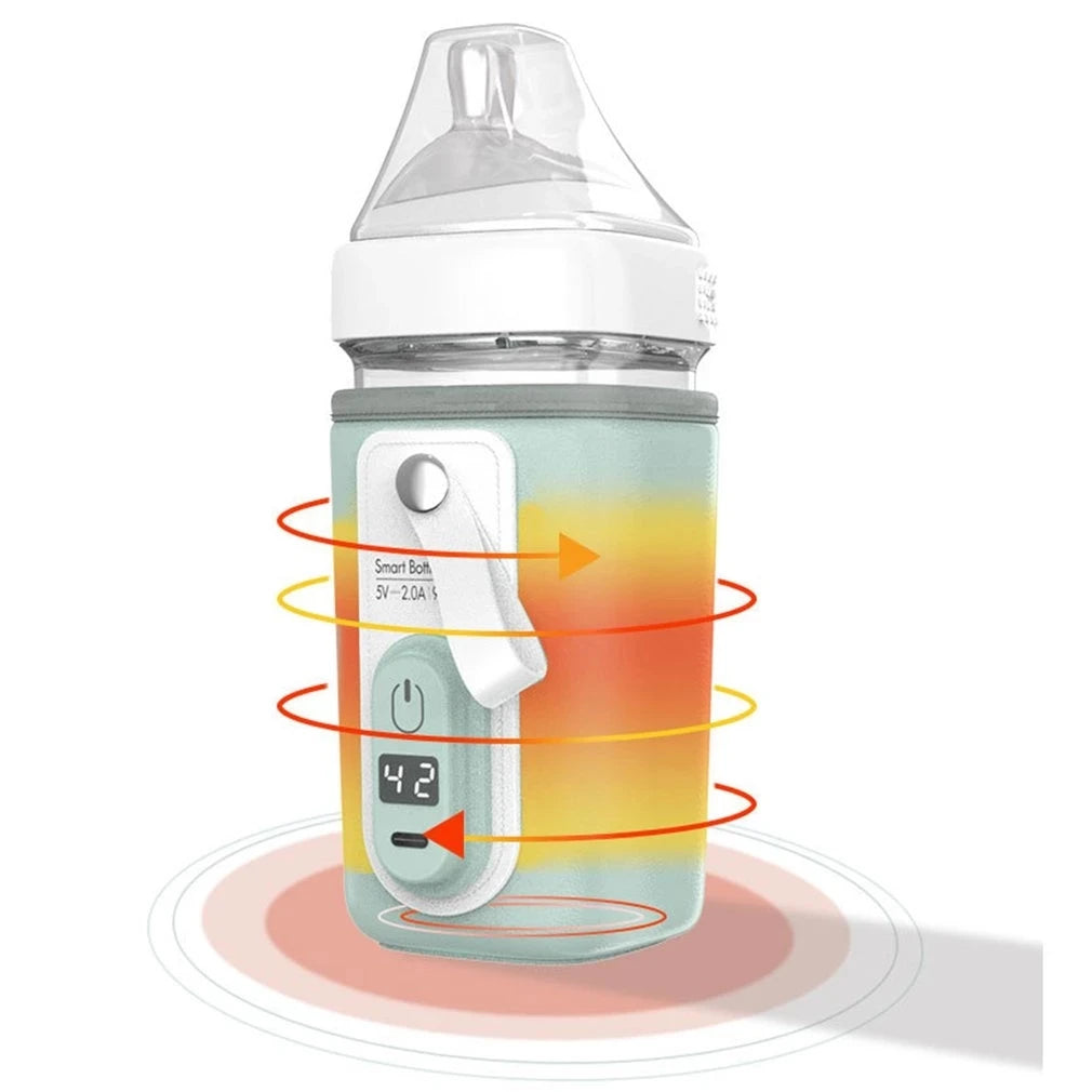 A bottle warmer with a digital display showing 42°C, wrapped in a gray sleeve with heating indicator arrows. The top is a transparent silicone nipple with a white collar.