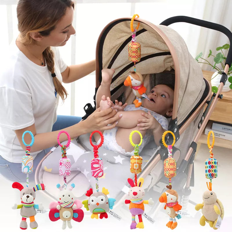 A mother interacts with her baby in a stroller, decorated with colorful hanging animal toys. The baby is lying comfortably, surrounded by a bright and playful environment.