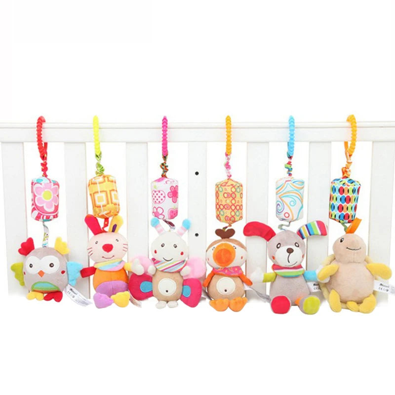 Colorful plush animal toys with bright patterns hang from spiraled hooks. The toys are a bunny, an owl, a butterfly, and two bears, each with distinct vibrant designs.