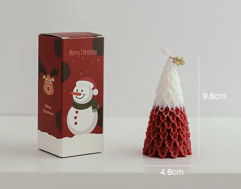 Red and white textured Christmas tree candle measuring 9.6cm tall and 4.6cm wide, placed beside a festive red box featuring a snowman and a reindeer with "Merry Christmas" text.