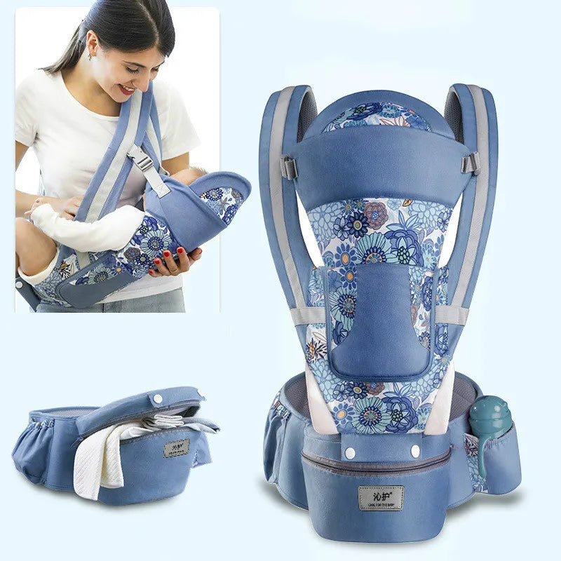 A floral-patterned blue baby carrier with padded straps and storage pockets. Inset image shows a woman holding a baby in the carrier, demonstrating its use.