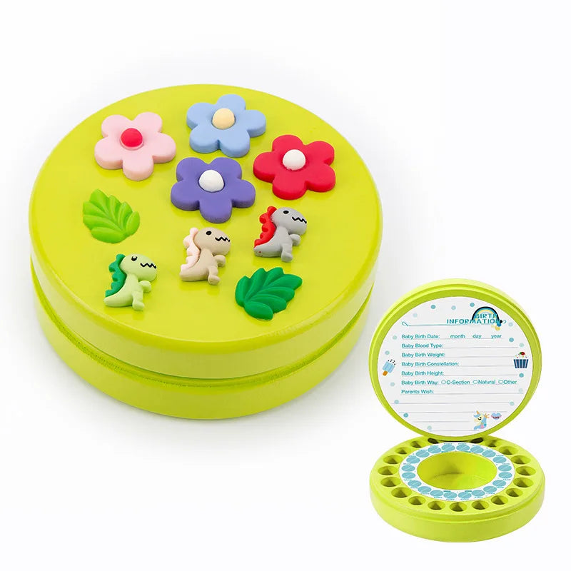 Round green box with colorful flower and dinosaur decorations on the lid. The inside features a circular space for storing items and a section for baby information details.