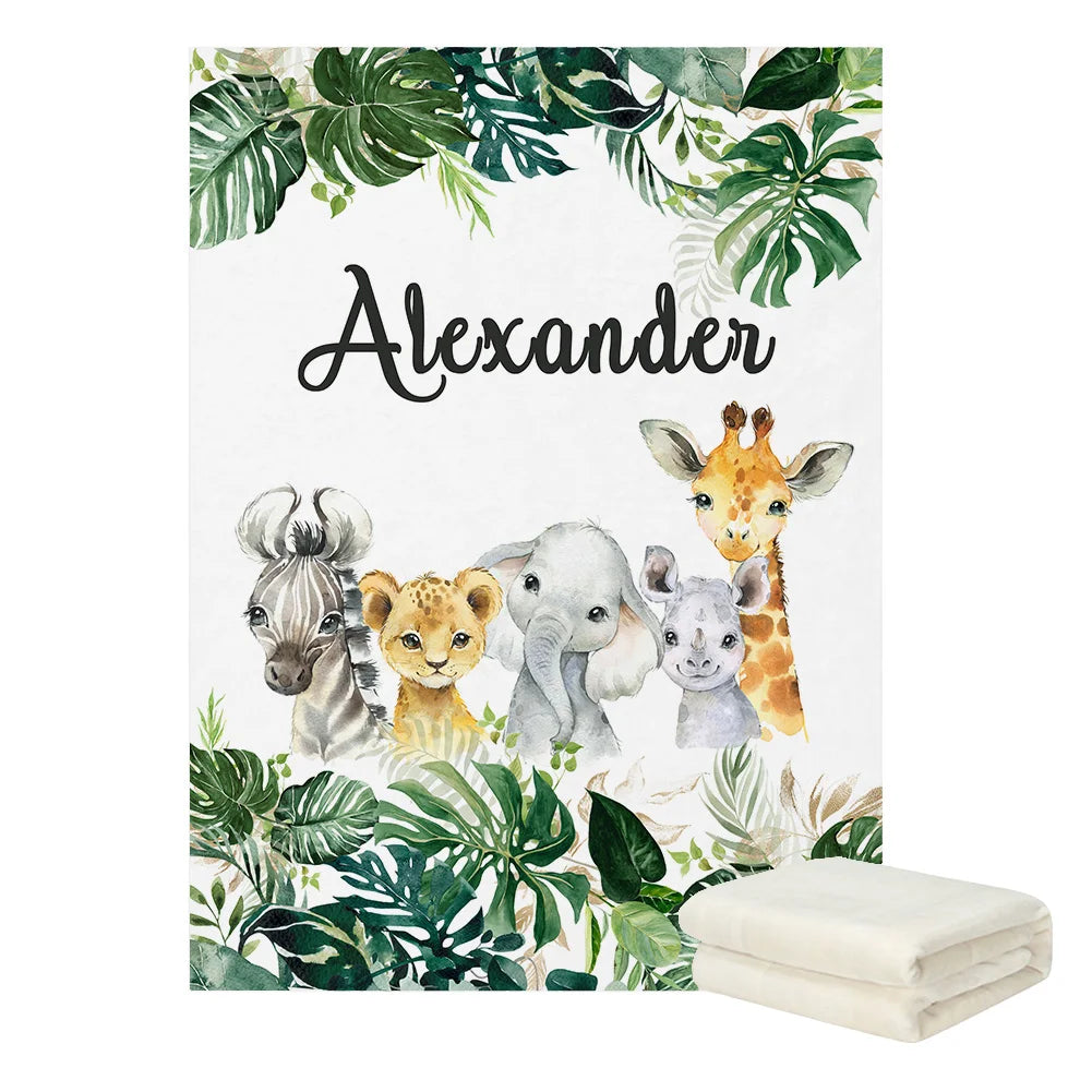 Baby blanket featuring a zebra, lion, elephant, rhinoceros, and giraffe with tropical leaves, personalized with the name "Alexander." Includes two folded blankets on the side.