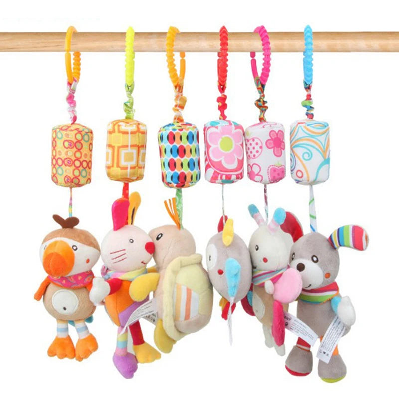 Colorful plush toys are hanging from a wooden rod, featuring various animals and characters with vibrant patterns and designs, connected by bright, patterned fabric loops.