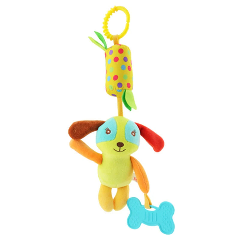 Colorful plush toy dog with mismatched ears and a blue bone-shaped teether. It hangs from a yellow ring attached to a polka-dotted cylindrical rattle with green fabric leaves.