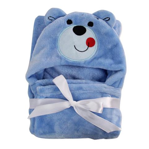 Plush blue baby blanket with a bear hood, featuring a smiling bear face embroidered with a red tongue. Tied with a white ribbon, the blanket is soft and cozy.
