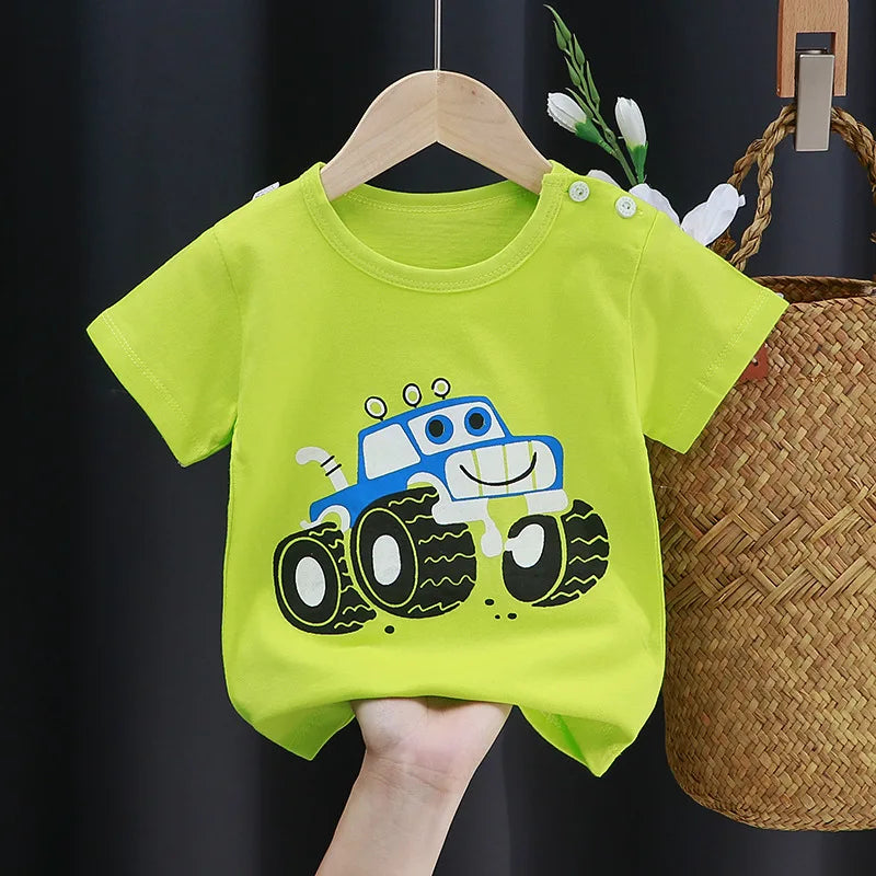 Bright green toddler t-shirt with a cheerful blue monster truck design. The shirt is on a hanger and features white button details on the shoulder.