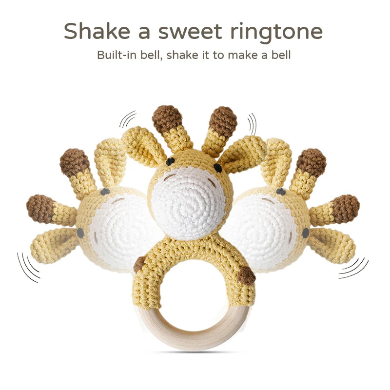 Crocheted giraffe-shaped rattle with a wooden ring. Text above reads, "Shake a sweet ringtone. Built-in bell, shake it to make a bell." Illustrates motion with sound lines.