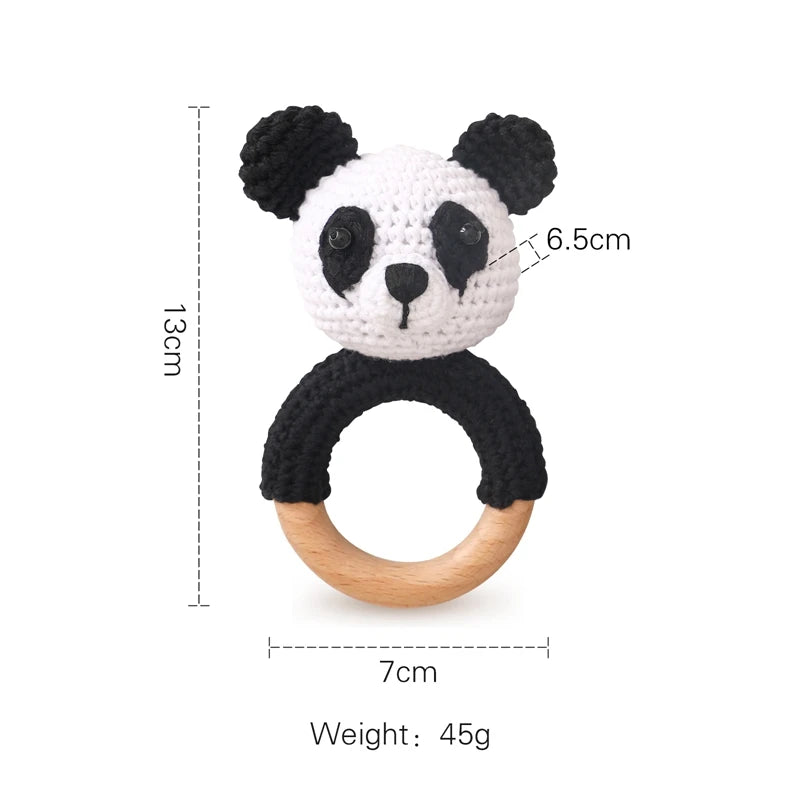 Crochet panda rattle with wooden ring. Panda head is white with black ears and patches, 13cm tall, 7cm wide, weighs 45g. Head is 6.5cm in diameter.