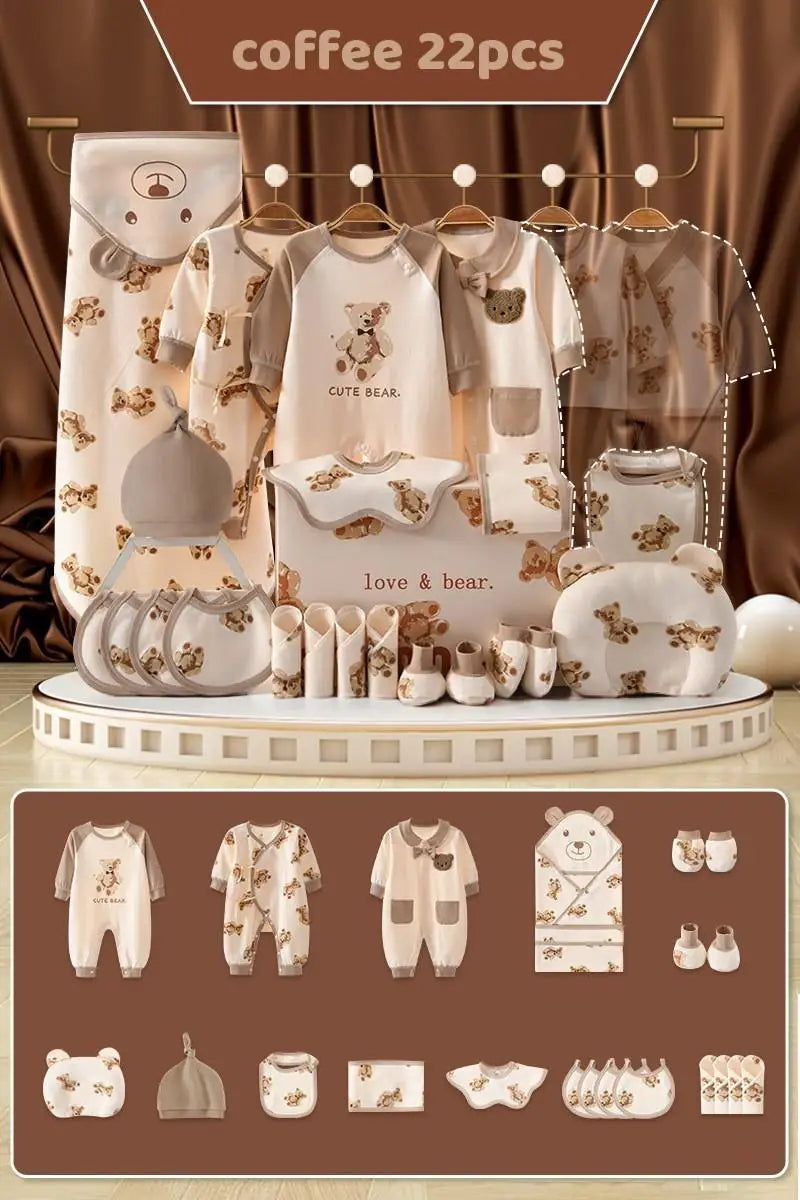 22-piece baby clothing set themed "Cute Bear," includes onesies, bibs, hats, mittens, blanket, and more in a brown and beige motif with bear designs, displayed on a taupe background.