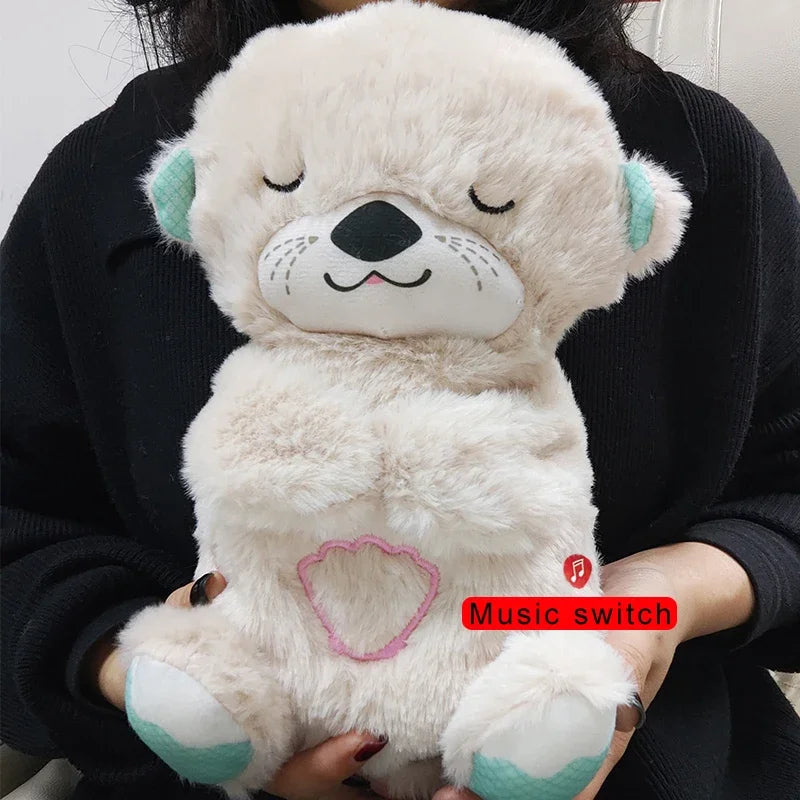 A person holds a fluffy beige plush toy with closed eyes and a content smile. It has teal ears and paws, featuring a red "Music switch" button and a pink heart outline on its belly.