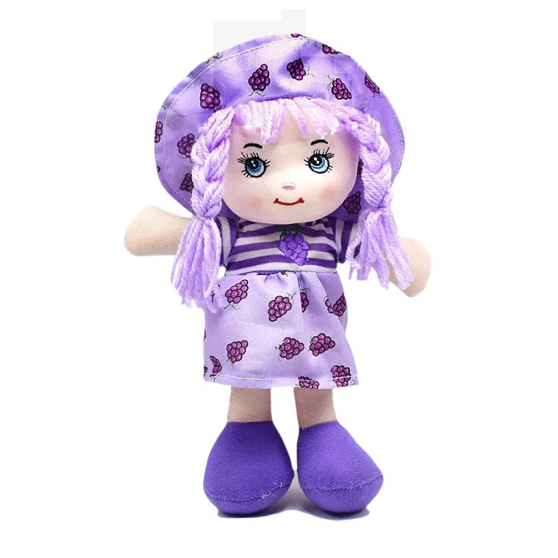 A plush doll with purple hair and outfit, decorated with grape patterns. It has a matching hat and shoes, with a friendly embroidered face and outstretched arms.