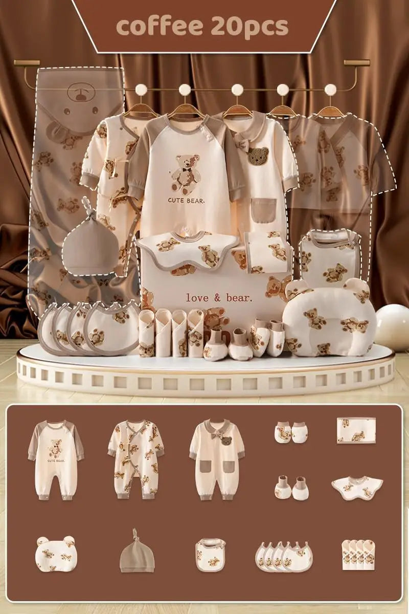 Set of 20 coffee-themed baby items, including clothing and accessories with bear designs, displayed elegantly. Features bibs, onesies, hats, and more against a rich brown backdrop.