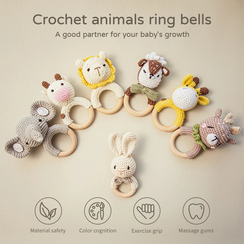 Crochet animal ring bells arranged in a half-circle. Includes an elephant, cow, lion, dog, giraffe, and deer. Text highlights material safety and benefits for babies.