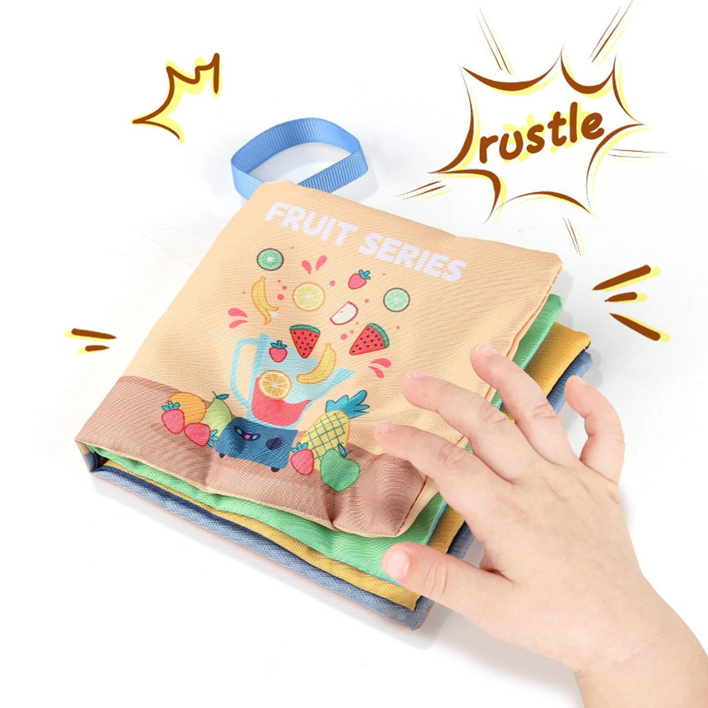 A child's hand touches a colorful fabric book titled "Fruit Series," featuring cartoon fruit illustrations. The word "rustle" is displayed, suggesting a sound effect.