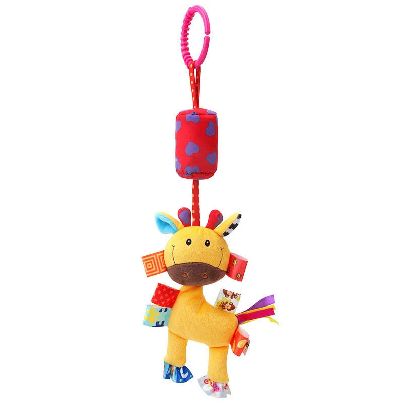 Colorful plush giraffe toy with a red polka-dot ring for hanging. Features multicolored ribbons, tags, and a cushioned tube. Ideal for infants' sensory play.