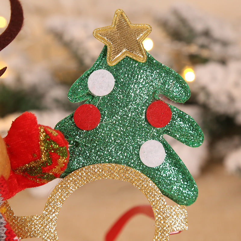 Glittery Christmas tree decoration on gold frames, adorned with a shiny star on top and red and white circular ornaments, with a blurred festive background.
