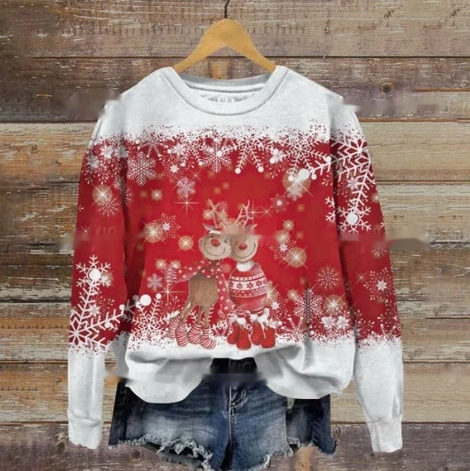 Red and white Christmas sweater featuring reindeer and snowflake designs, paired with denim shorts, displayed on a wooden background.