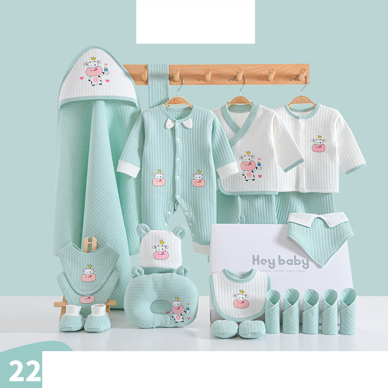 Baby clothing set in mint green and white with cartoon cow designs. Includes a hooded towel, onesie, bibs, mittens, and more, neatly arranged against a light background.