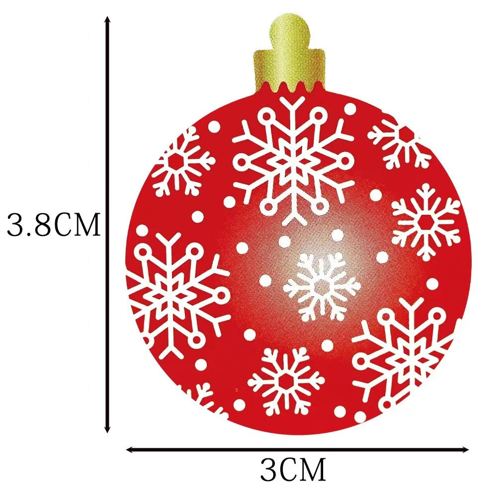 Red Christmas ornament with white snowflake patterns, measuring 3.8 cm in height and 3 cm in width, topped with a golden cap.