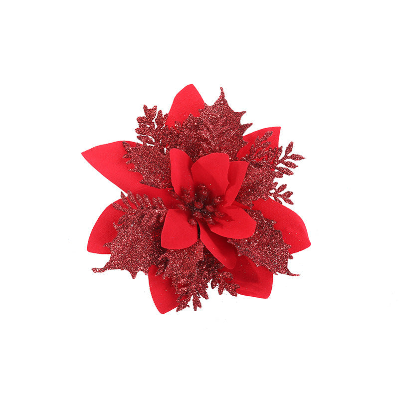 Vibrant red poinsettia with glittering leaves and petals against a white background. The flower's textured elements add a festive and decorative touch.