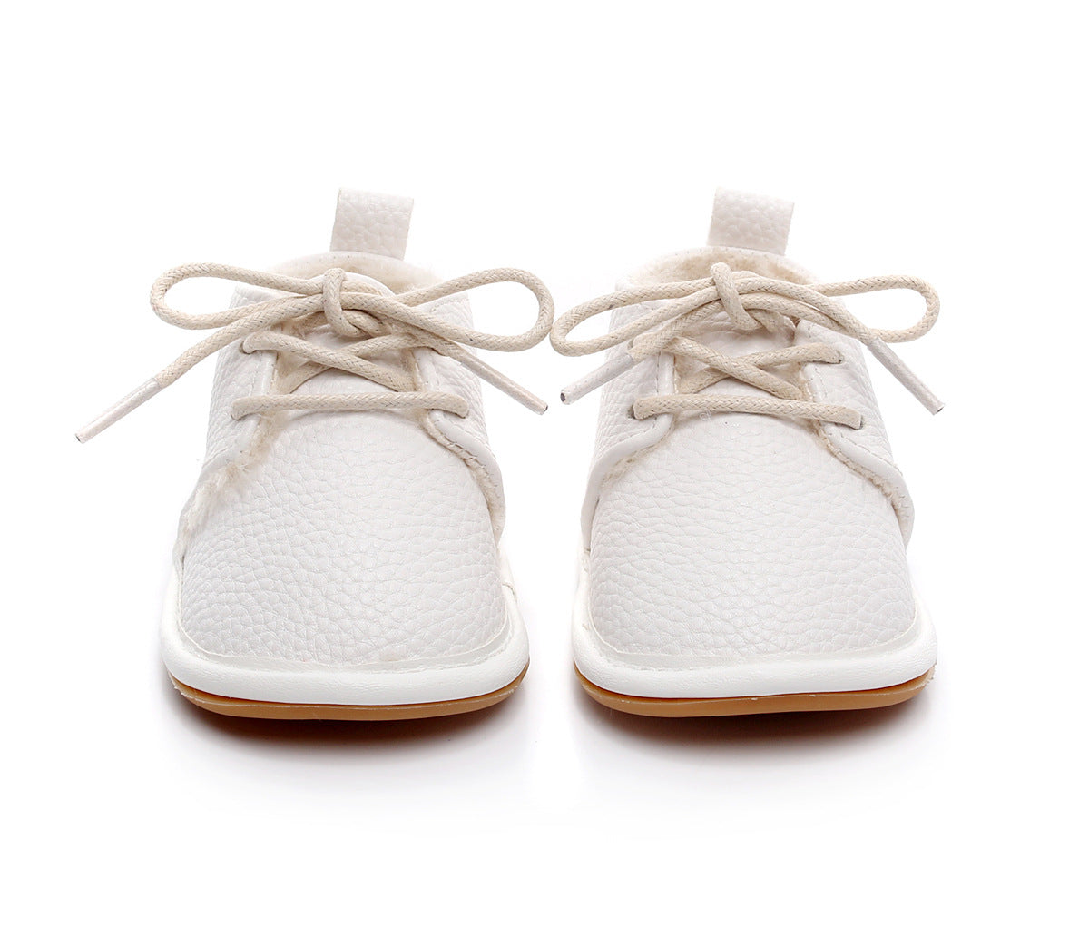 White textured baby shoes with beige laces and soft soles, seen from the front against a white background.