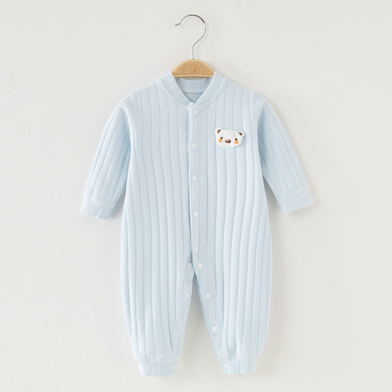 Light blue ribbed baby romper with long sleeves and white buttons, featuring a small bear face patch on the chest, hanging on a wooden hanger against a white background.