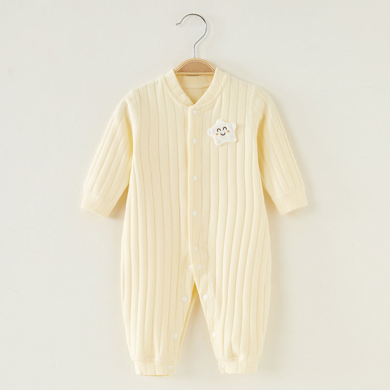 Cream-colored ribbed baby onesie on a hanger, featuring a cute smiling star patch on the chest, and button closures running down the front.