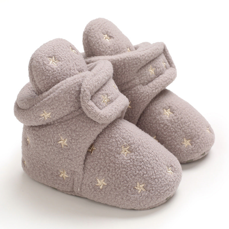 Soft, grey baby booties adorned with small, embroidered stars, designed with a fold-over cuff for warmth and comfort.