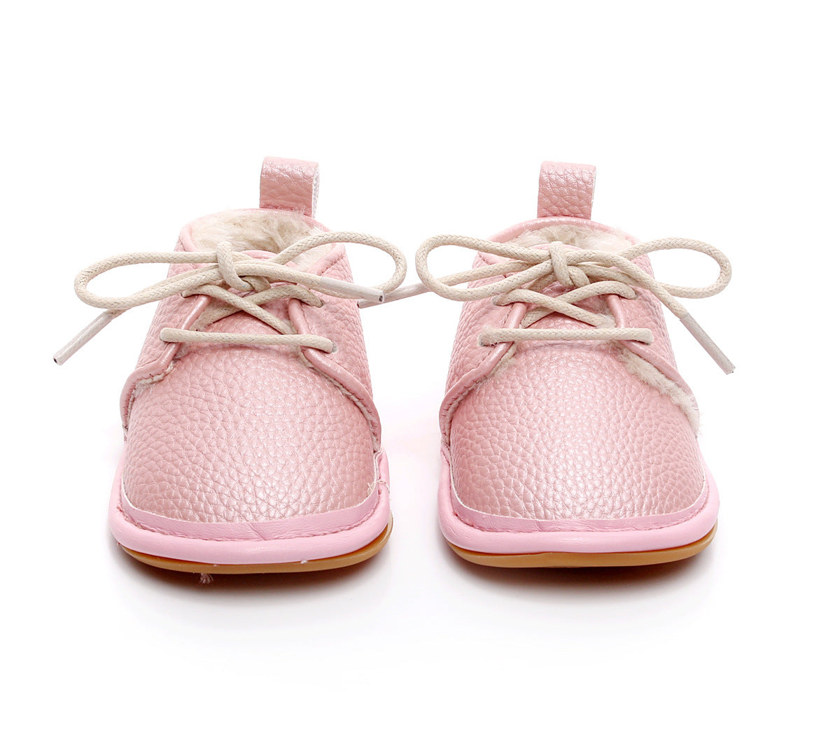 Pink baby shoes with soft, textured leather and cream laces, lined with fur. Shoes feature a loop on the heel and light brown soles, displayed on a white background.