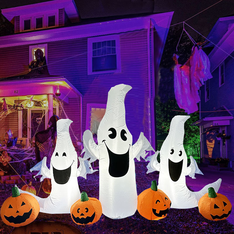 Three inflatable ghosts with big smiles stand among jack-o'-lanterns in front of a house decorated with cobwebs and lights, creating a festive Halloween scene.