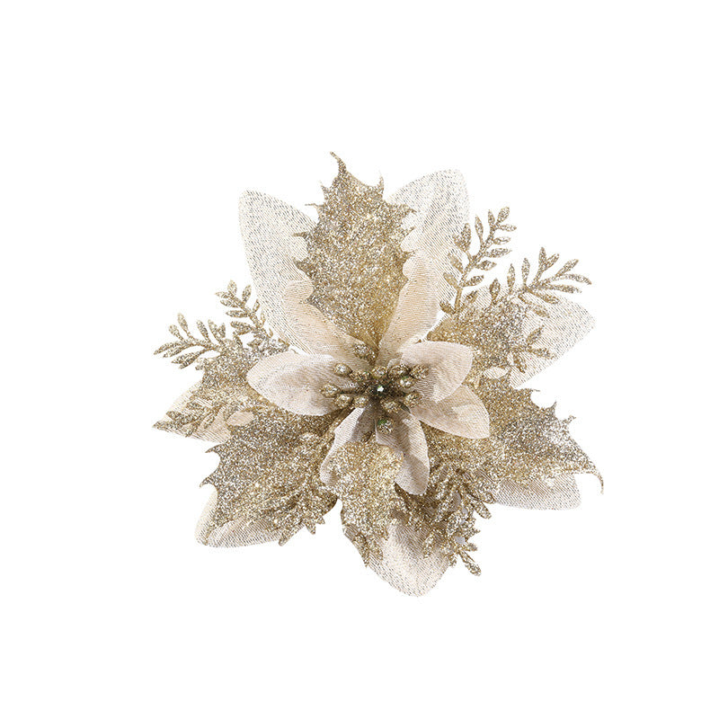Gold poinsettia with glittery leaves and berries, featuring textured petals and shimmering accents, set against a white background.