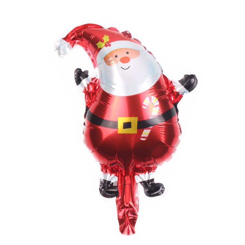A festive, shiny Santa Claus foil balloon with a red suit, black belt, and candy cane design, wearing a red hat with holly, cheerfully waving.
