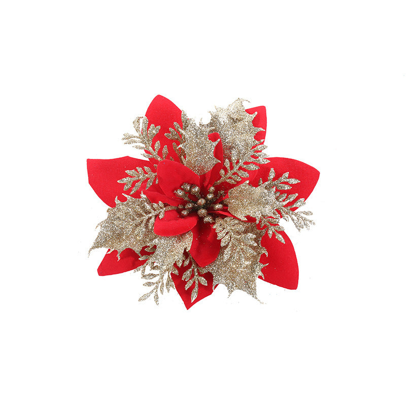 A decorative red poinsettia with glittering gold leaves on a white background, creating a festive and elegant appearance.