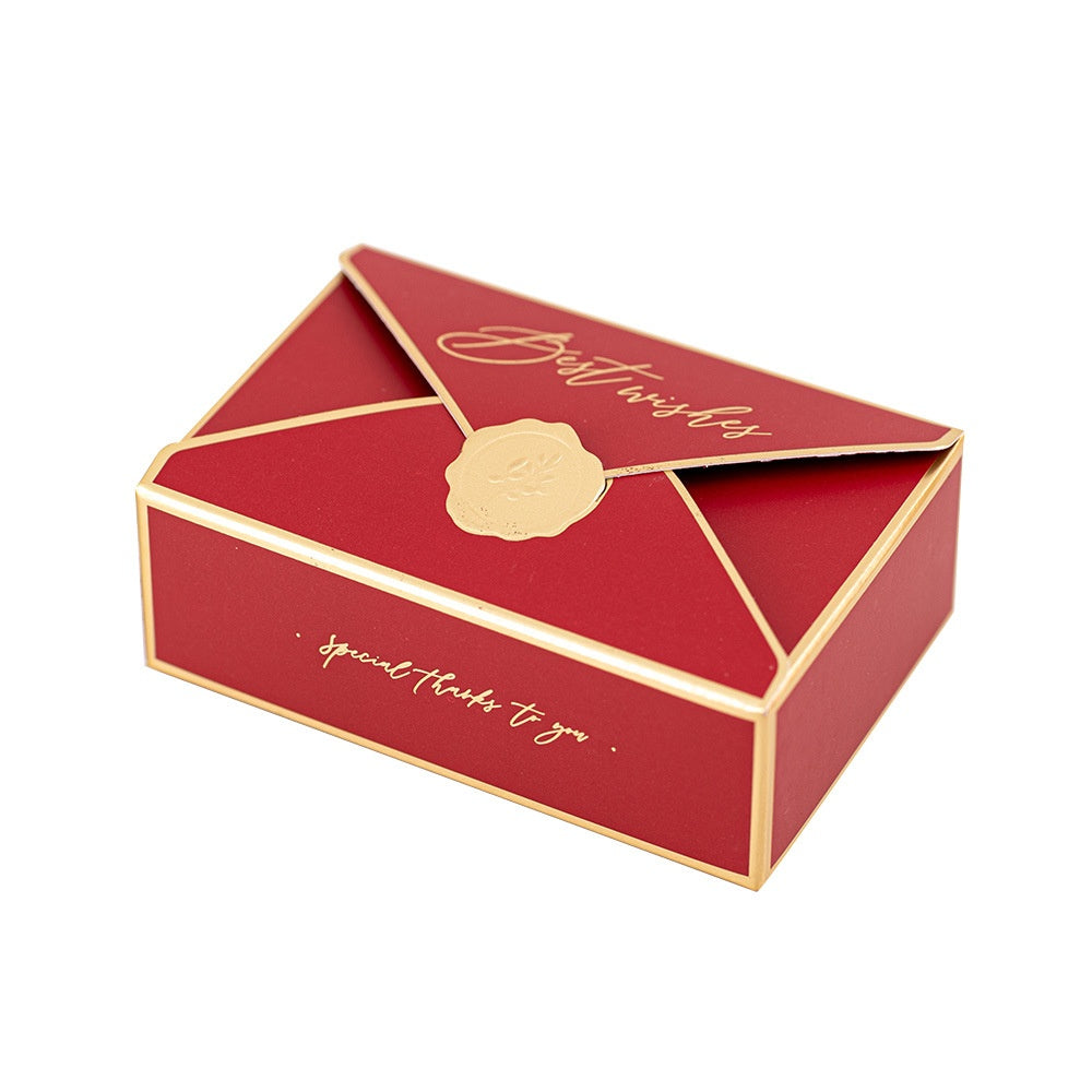 Red and gold gift box shaped like an envelope with gold script that reads "Best wishes." A gold seal decorates the top, and the side says "special thanks to you."