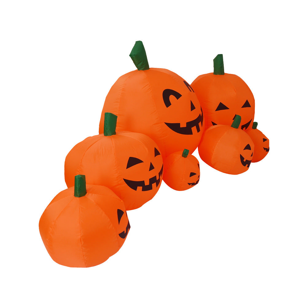 Inflatable Halloween pumpkins with smiling faces, arranged in a row. The pumpkins vary in size, with green stems, creating a festive and playful display.
