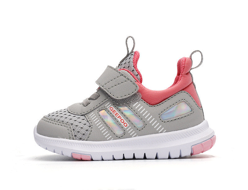Gray and pink children's sneaker with a Velcro strap, mesh detailing, and white sole. Features iridescent accents and pull loops on the tongue and heel.