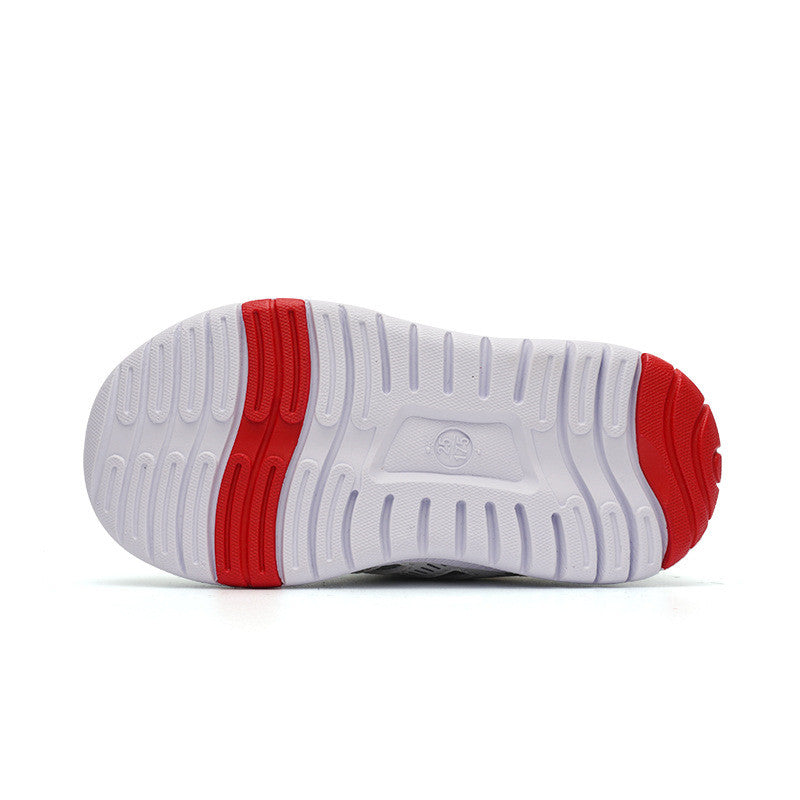 White sneaker outsole with prominent red accents on the heel and midsole. The tread features a combination of circular and linear patterns for grip.