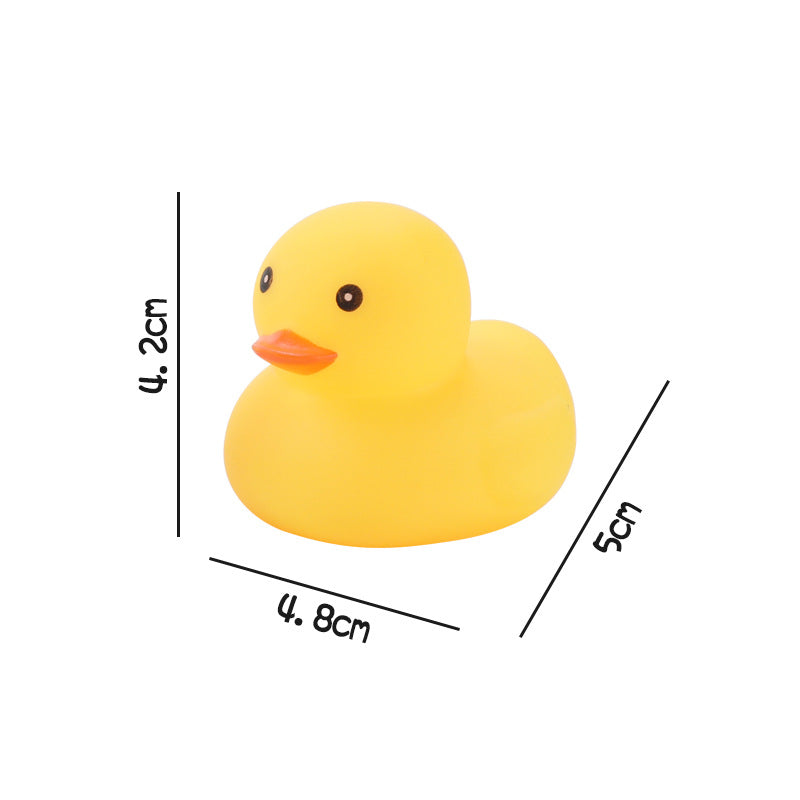 A small yellow rubber duck with an orange beak, measuring 4.2 cm tall, 4.8 cm wide, and 5 cm long, positioned against a white background.