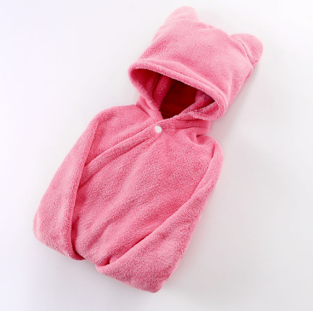 Pink fleece hoodie with bear ears on the hood, featuring a single white button at the neck. The soft fabric has a plush texture, suitable for keeping warm and cozy.